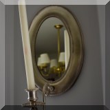 D01. One of a pair of silver tone mirrored candle sconces. 